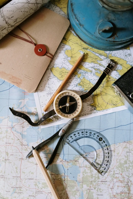 a map, compass, and other items on a table, navy, tools, curated collections, thumbnail