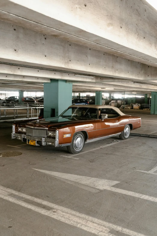 a car is parked in a parking garage, an album cover, by Jesse Richards, unsplash, swagger! lowrider culture, brown, square, open top