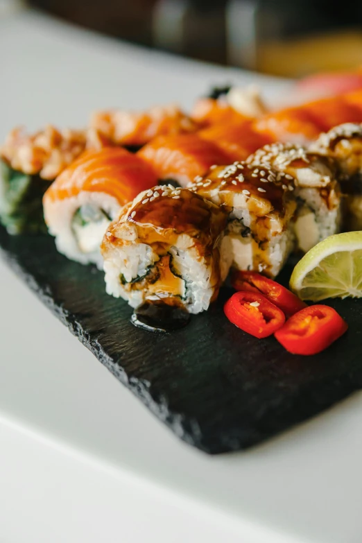 a close up of a plate of food on a table, inspired by Maki Haku, unsplash, 6 pack, made of glazed, spicy, slate