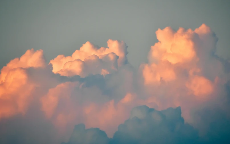 a plane flying through a cloud filled sky, by Matt Cavotta, unsplash, romanticism, toned orange and pastel pink, cumulus cloud tattoos, humid evening, 1 5 0 4