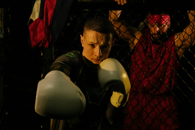 a close up of a person wearing boxing gloves, an album cover, pexels contest winner, combat scene, actor, (night), grime