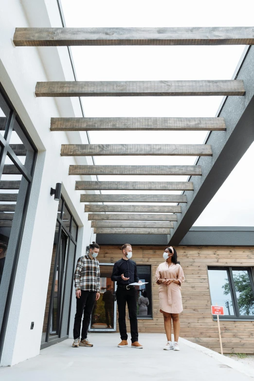 a group of people standing outside of a building, wooden ceiling, modern details, dwell, commercial