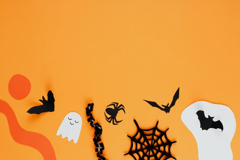 a group of halloween decorations on an orange background, by Helen Stevenson, trending on pexels, paper cut out, on a pale background, white background, crawling out of a dark room