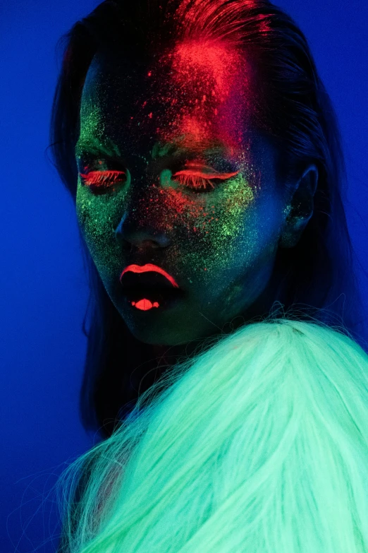 a woman with glowing paint on her face, an album cover, inspired by Elsa Bleda, trending on pexels, holography, coloured gel studio light, high fashion photography, blue and green and red tones, bold rave outfit