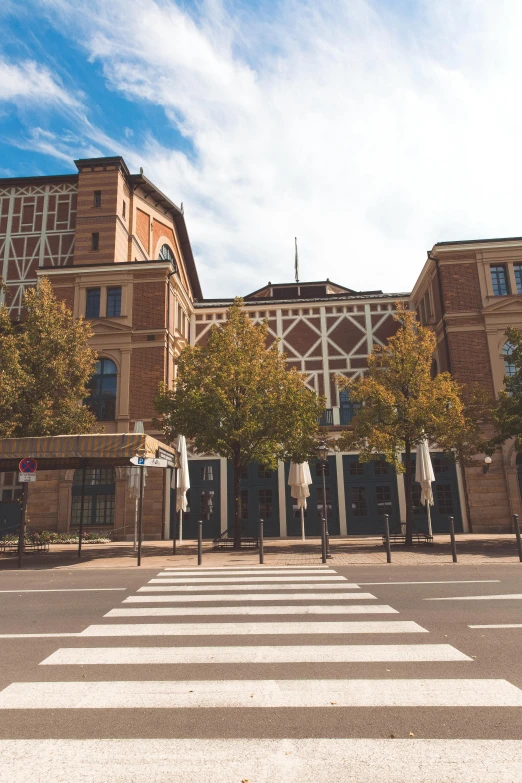 a crosswalk in front of a building on a sunny day, inspired by Albert Paris Gütersloh, unsplash, paris school, war theatre, 2 5 6 x 2 5 6 pixels, exterior wide shot, rennes - le - chateau