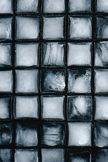 a black and white photo of ice cubes, inspired by Andreas Gursky, unsplash, square, blue cobblestones, grid of styles, cold colour temperature