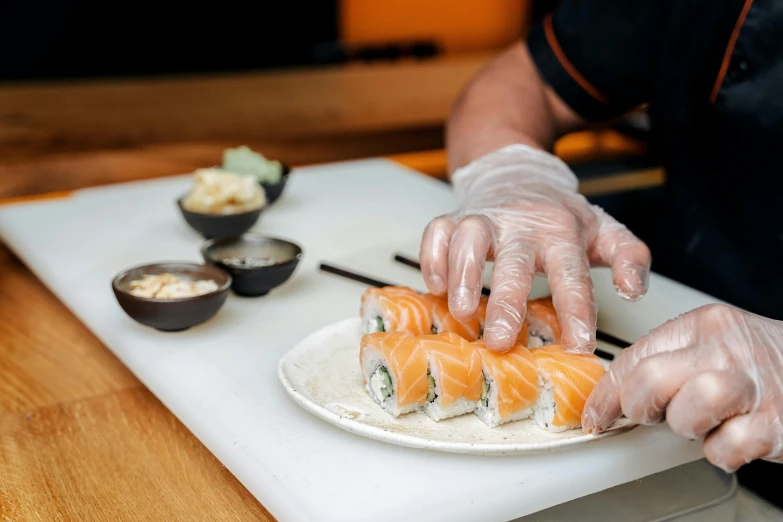 a person cutting a piece of sushi on a cutting board, offering a plate of food, ninja scrolls, mesmerising, creamy