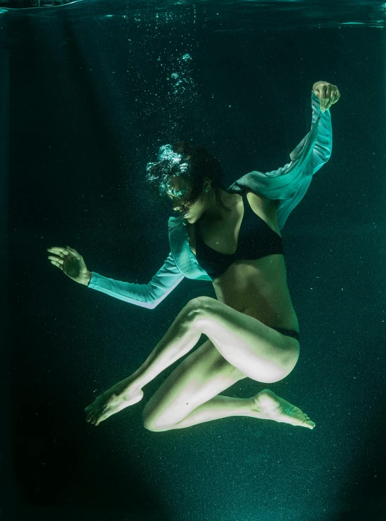 a woman in a bikini swims under water, inspired by Elsa Bleda, hd award-winning photo, deep green, full frame, 4l