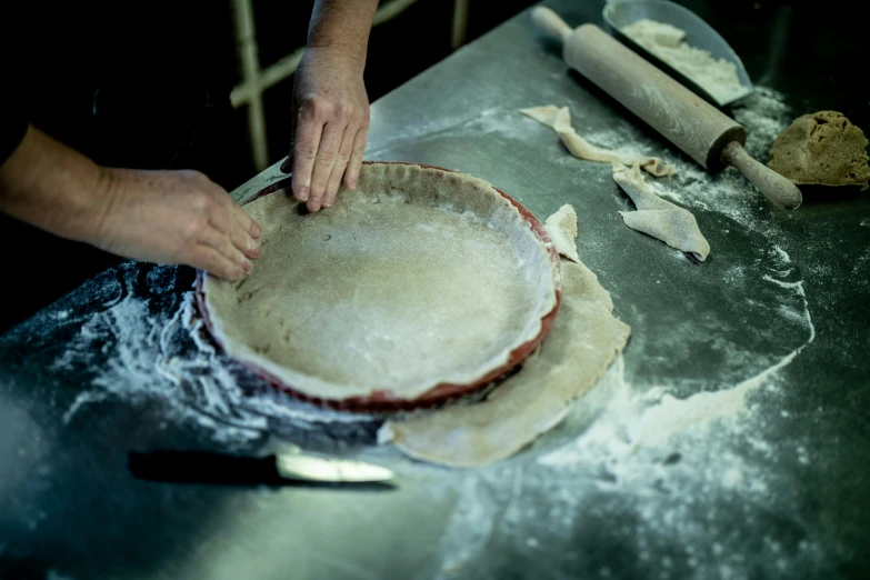 a person making a pie in a kitchen, pexels contest winner, process art, “ iron bark, in a workshop, parchment, gourmet and crafts