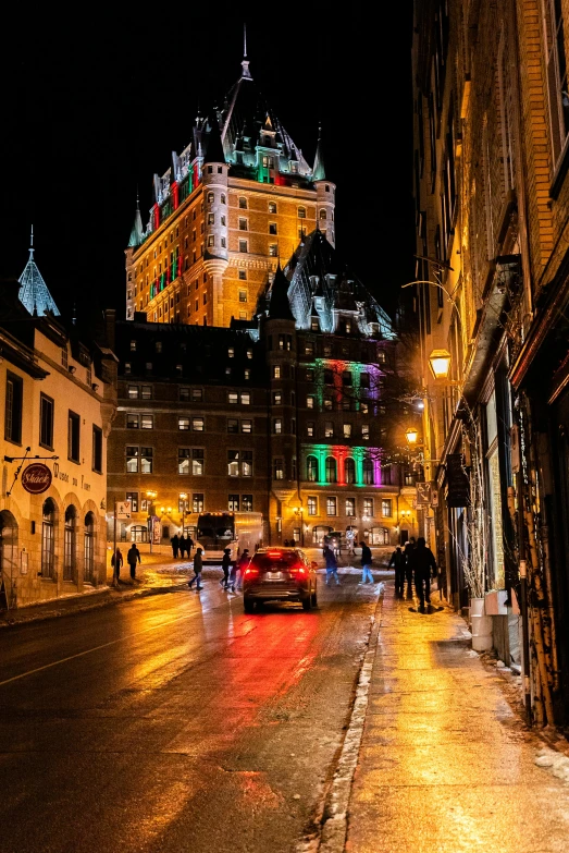 a city street at night with a castle in the background, a photo, by Pierre Toutain-Dorbec, pexels contest winner, chateau frontenac, colorful lights, square, slide show