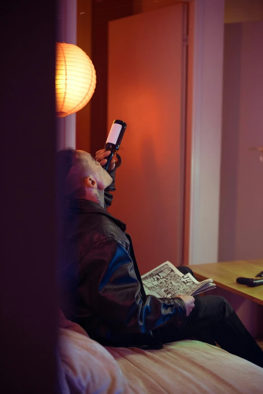 a person sitting on a bed using a cell phone, by Jan Tengnagel, happening, cinematics lighting, an escape room in a small, bjørn skalldrasson, reading a newspaper