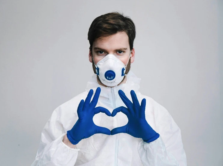 a man in a hazmat suit making a heart with his hands, pexels contest winner, blue! and white colors, face mask, pewdiepie, clean design