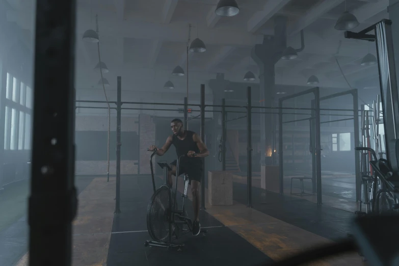 a man riding a bike next to a woman on a bike, a 3D render, inspired by jessica rossier, pexels contest winner, realism, in a gym, volume raytracing fog, atmospheric establishing shot, pbr render