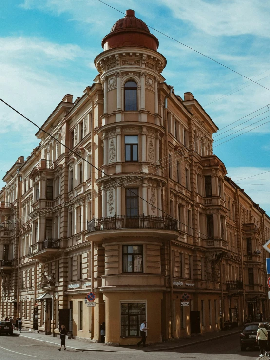 a tall building sitting on the side of a street, a photo, inspired by Illarion Pryanishnikov, pexels contest winner, neoclassicism, brown, profile image, wide high angle view, southern slav features