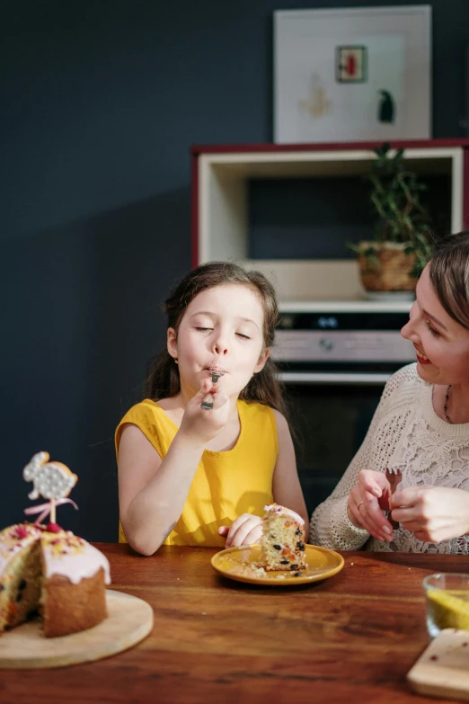 a woman and two young girls sitting at a table eating cake, pexels contest winner, manuka, sweet home, profile image, modern design