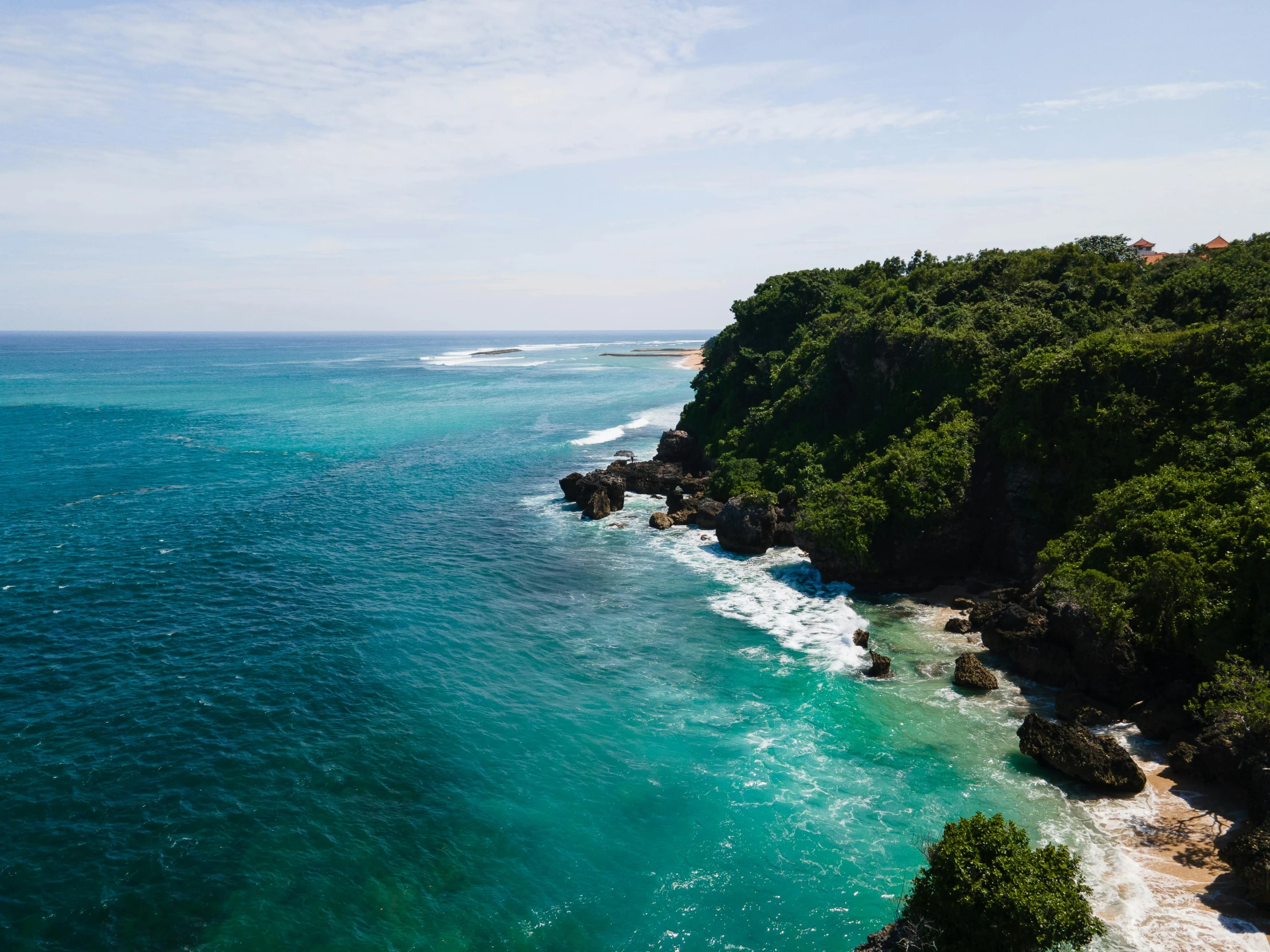 a large body of water next to a lush green hillside, pexels contest winner, happening, ocean cliff side, turquoise ocean, bali, australian beach