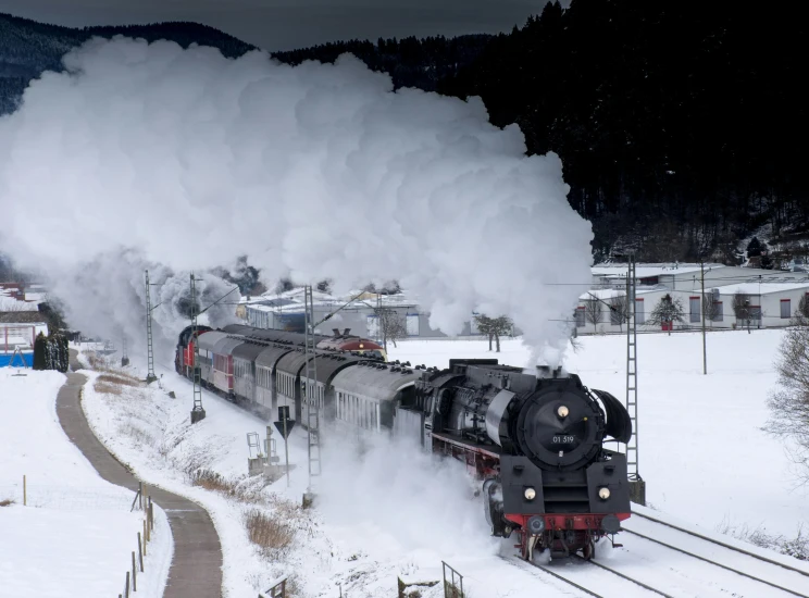 a train is coming down the tracks in the snow, by Werner Gutzeit, pexels contest winner, smoke in front, big engine, avatar image