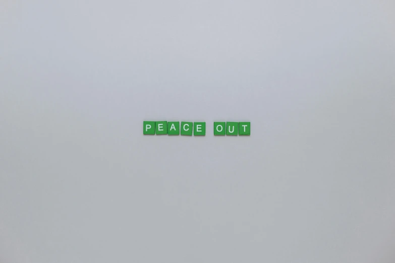 a couple of green letters sitting on top of a white surface, an album cover, by Weiwei, peace and quiet, # glazersout, blackout, on grey background