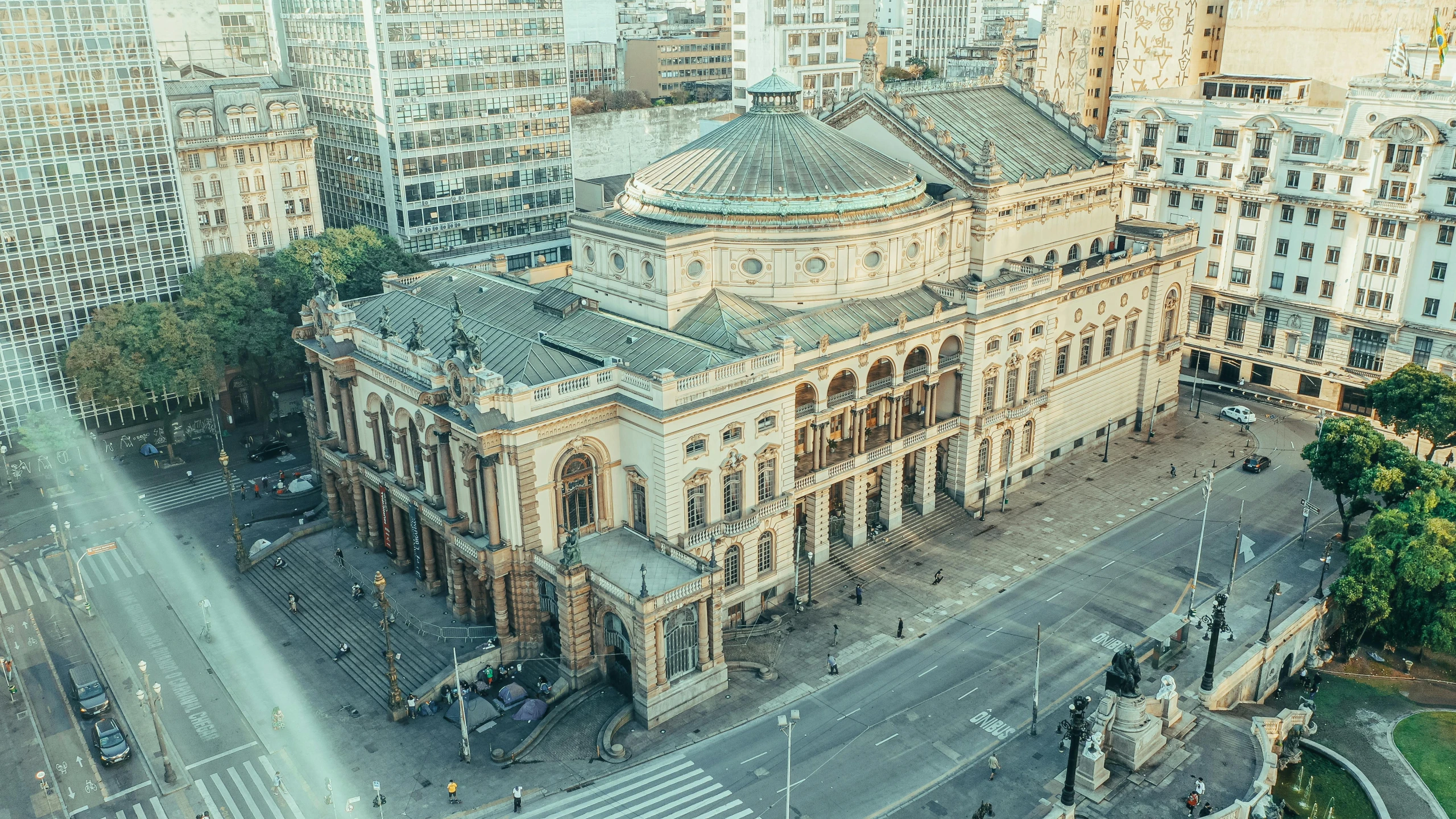 a large building sitting in the middle of a city, by Emma Andijewska, pexels contest winner, art nouveau, khedival opera house, aerial, square, thumbnail