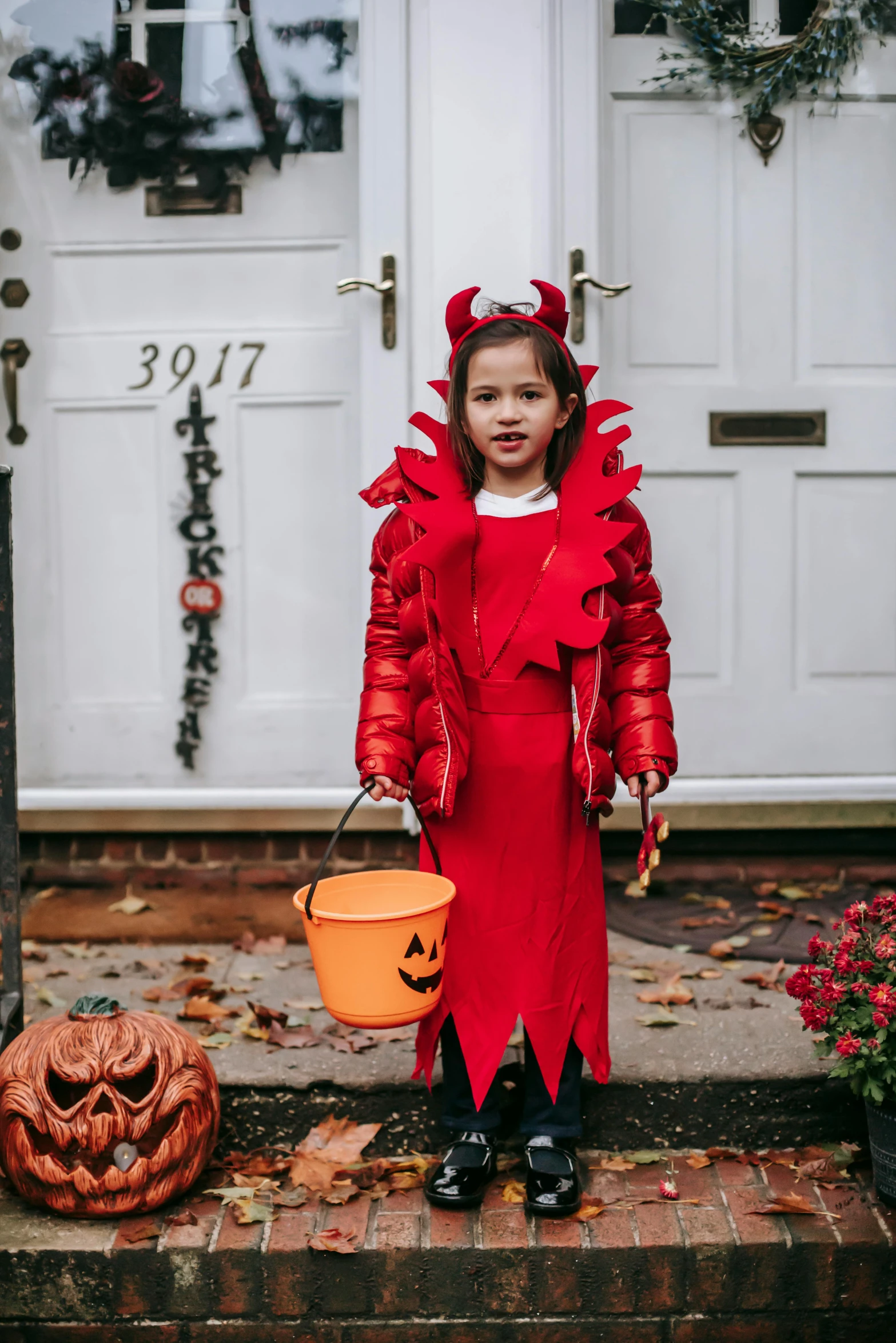 a little girl dressed in a red devil costume, pexels contest winner, trick or treat, lobster themed armour, gif, grainy