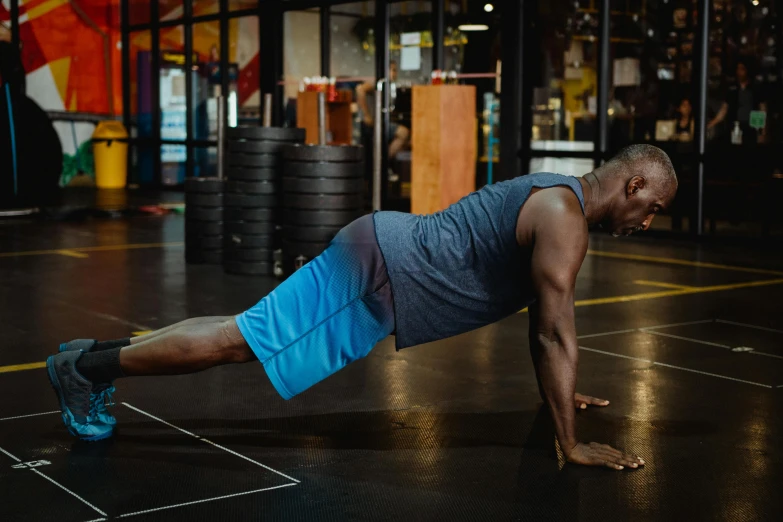 a man doing push ups in a gym, by Meredith Dillman, pexels contest winner, figuration libre, godwin akpan, profile image, thumbnail, aged 4 0