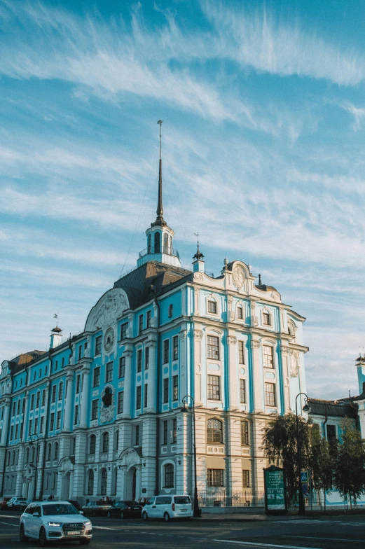 a large blue building sitting on the side of a road, inspired by Illarion Pryanishnikov, pexels contest winner, neoclassicism, black domes and spires, cyan and gold scheme, 000 — википедия, panorama