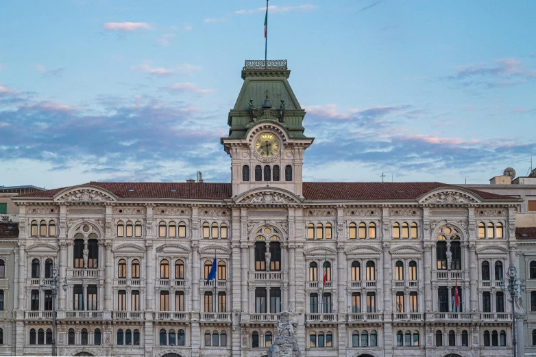 a large building with a clock tower on top of it, inspired by Vincenzo Cabianca, in the evening, megatall building, ornately dressed, profile image