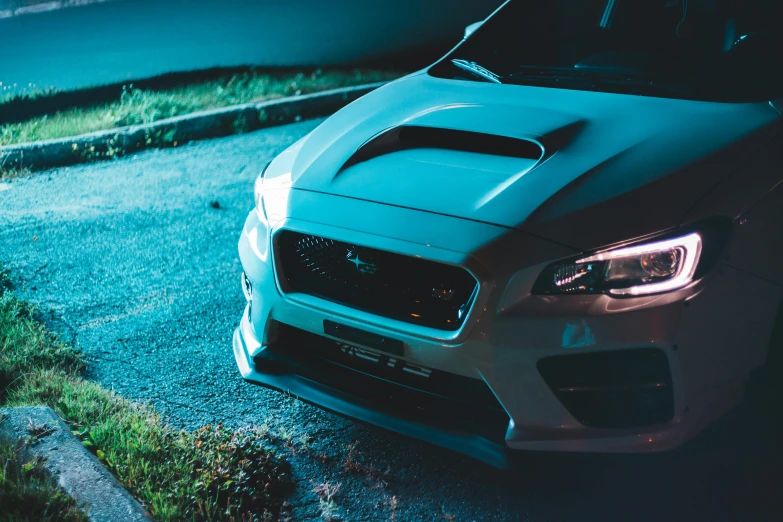 a car parked on the side of a road at night, pexels contest winner, auto-destructive art, wrx golf, dynamic pearlescent teal light, extremely detailed frontal angle, side lighting xf iq4