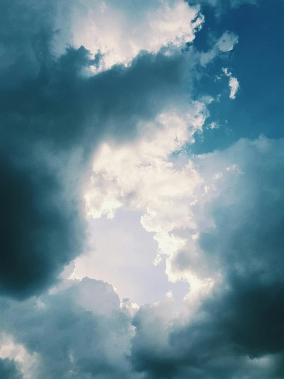 a plane flying through a cloudy blue sky, inspired by Elsa Bleda, unsplash, light and space, ☁🌪🌙👩🏾, in this ominous scene, major arcana sky, a still of an ethereal