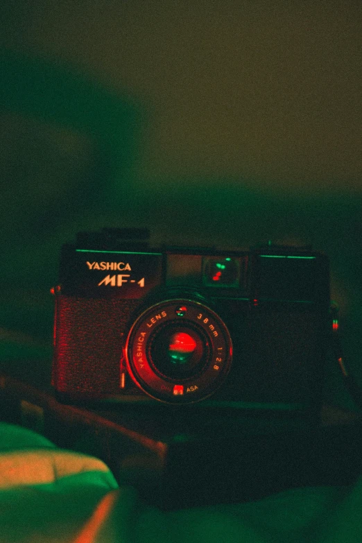 a camera sitting on top of a bed, inspired by Elsa Bleda, unsplash contest winner, visual art, red and green lighting, yashica t 4, camera looking up, captured in low light