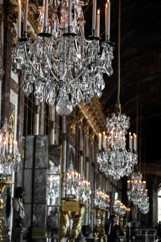 a room with a bunch of chandeliers hanging from the ceiling, by Nina Hamnett, baroque, hall of mirrors, crisp lighting and edges, w