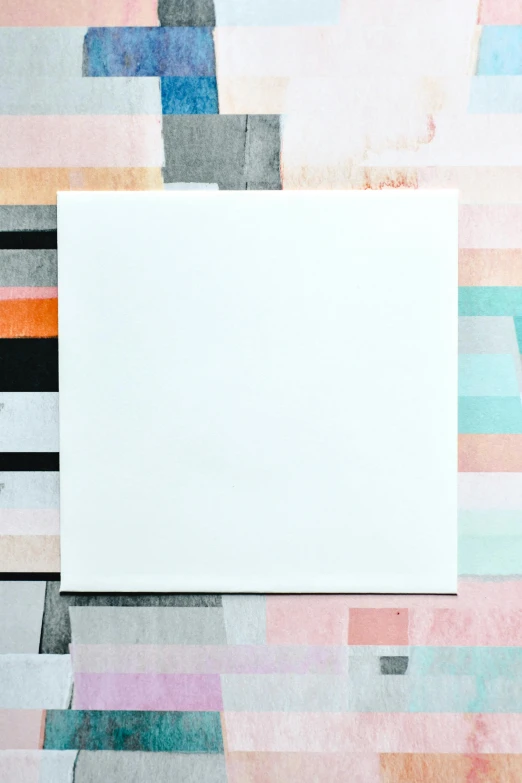 a piece of paper sitting on top of a table, a minimalist painting, inspired by Frederick Hammersley, unsplash, color field, 144x144 canvas, white metallic, promo image, facing away