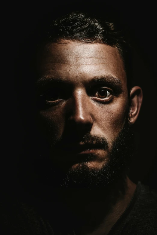 a man with a beard in the dark, an album cover, pexels contest winner, hyperrealism, strong eyes, tom hardy, dramatic soft shadow lighting, ( ( theatrical ) )