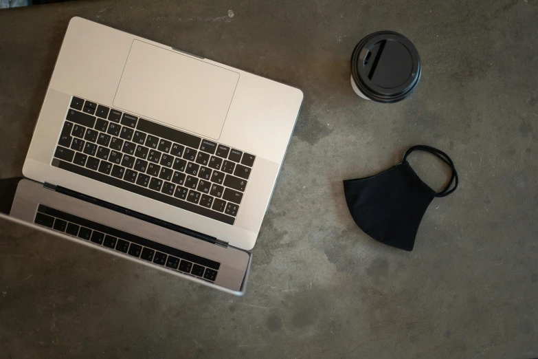 a laptop computer sitting on top of a table, pexels, minimalism, black facemask, silver, high angle, ignant