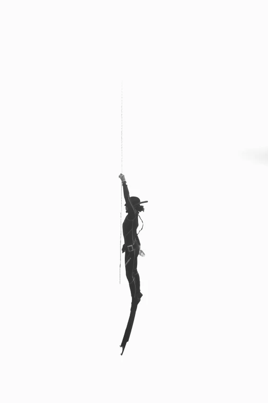 a black and white photo of a person flying a kite, an album cover, by Sergio Burzi, unsplash, conceptual art, pole dancing, ffffound, ( ( spiderwoman ) ), made of wire