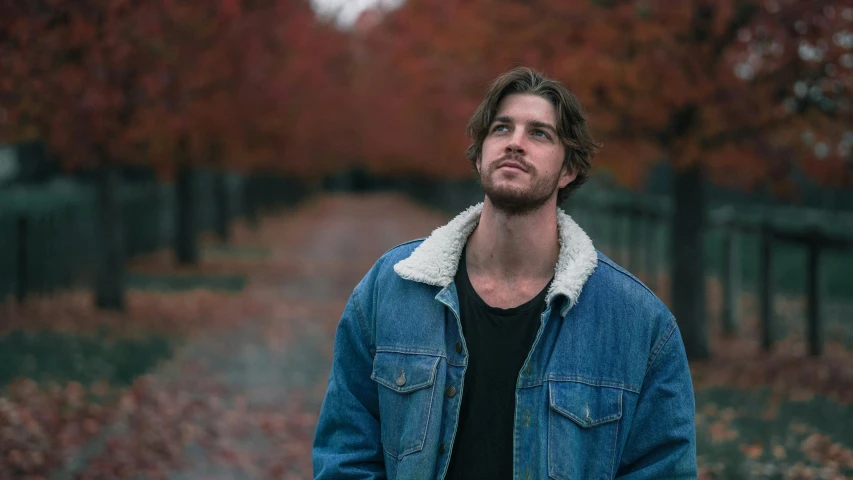 a man standing in the middle of a road, an album cover, pexels contest winner, fall foliage, thick jawline, sydney hanson, casual pose