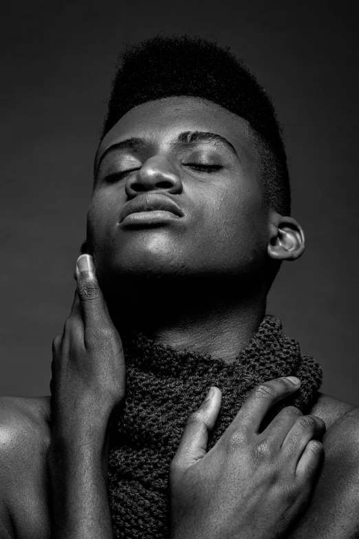 a black and white photo of a man wearing a scarf, an album cover, inspired by Chinwe Chukwuogo-Roy, pexels contest winner, non binary model, square masculine jaw, jaylen brown, hand on his cheek