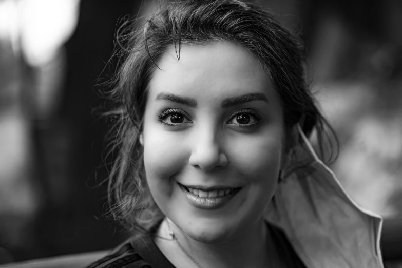 a black and white photo of a woman smiling, a black and white photo, hurufiyya, portrait sophie mudd, nekro petros afshar, uploaded, avatar image