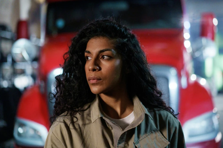 a woman standing in front of a red truck, pexels, serial art, from netflix's arcane, aida muluneh, wearing ripped dirty flight suit, arab ameera al-taweel