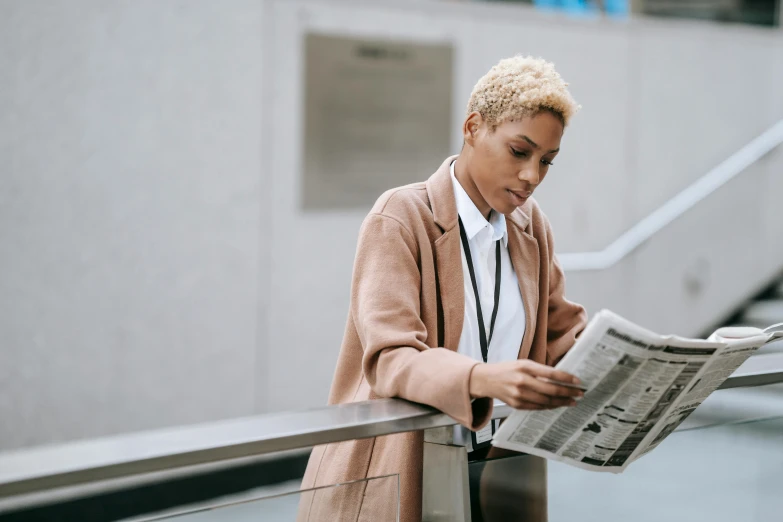 a woman reading a newspaper on an escalator, trending on pexels, private press, light brown coat, female in office dress, ashteroth, realistic »