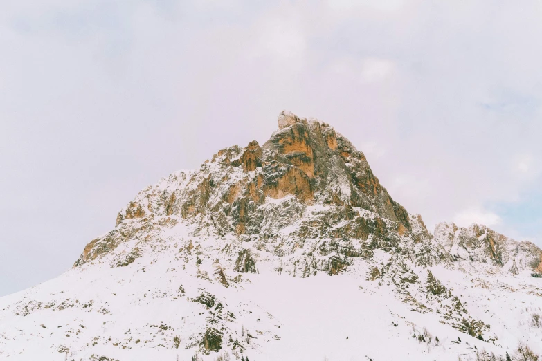 a person standing on top of a snow covered mountain, large rocky mountain, winter photograph, high details photo, unsplash photography