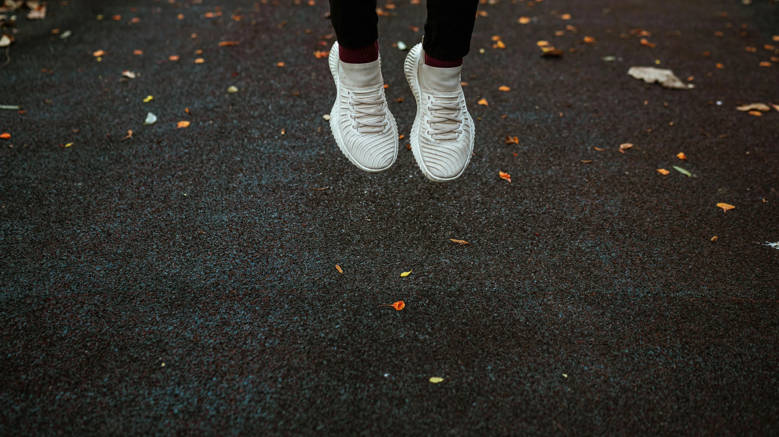 a person standing on a street with their feet in the air, pexels contest winner, realism, soft white rubber, at the park, 5k, autumnal