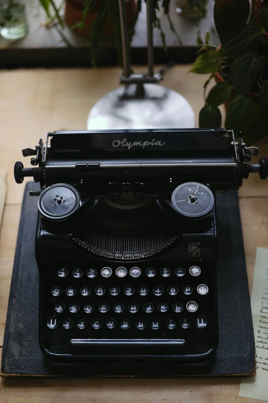 a black typewriter sitting on top of a wooden table, olympus, thumbnail, abcdefghijklmnopqrstuvwxyz, multiple stories