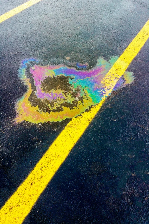 a fire hydrant sitting on the side of a road, chalk art, by Jan Rustem, land art, radial color dispersion, oil slick in the water, snapchat photo, rainbow liquids