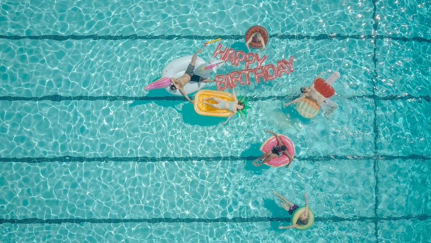 a group of people swimming in a pool, by Emma Andijewska, pexels contest winner, hyperrealism, happy birthday, hight decorated, drone photo, ilustration