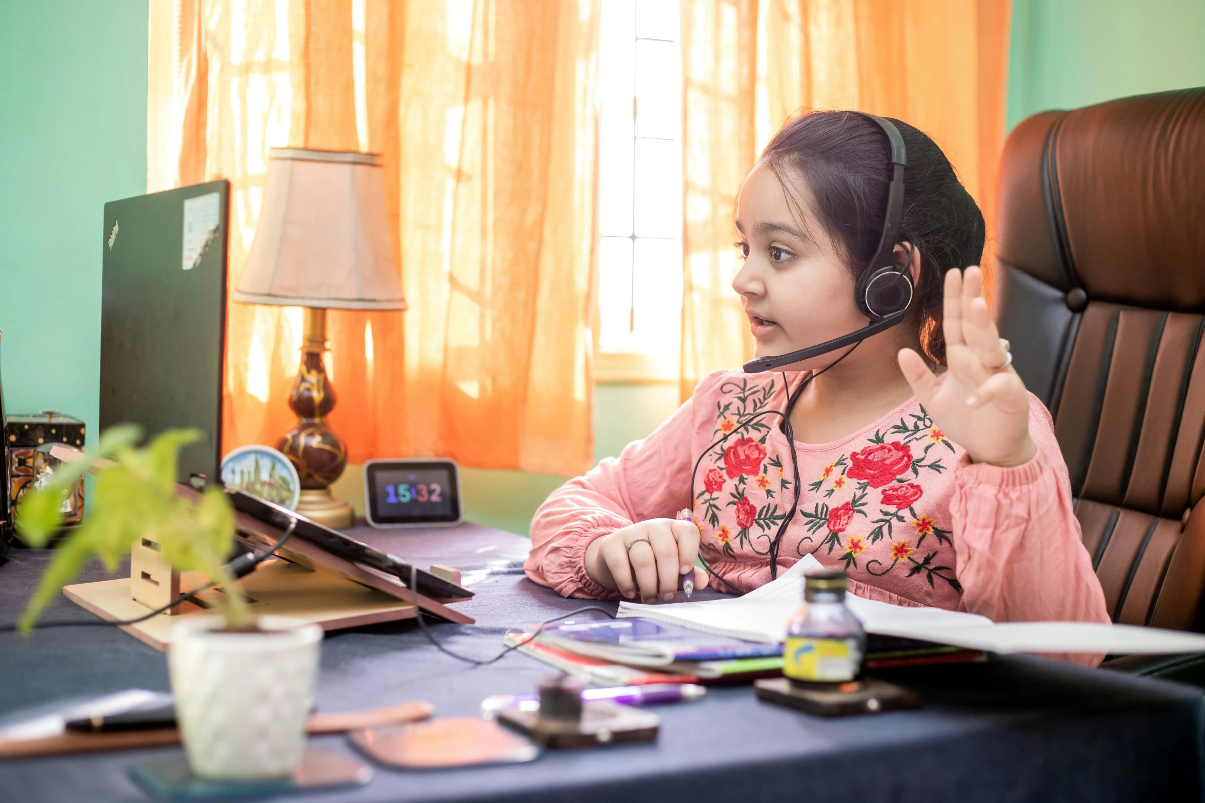 a little girl sitting at a desk in front of a computer, by Julia Pishtar, pexels contest winner, hurufiyya, wearing headset, india, avatar image, finger