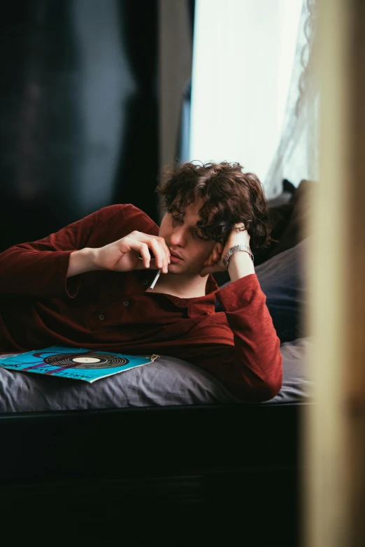 a man laying on a bed talking on a cell phone, inspired by Nan Goldin, trending on pexels, finn wolfhard, curled up on a book, gaming, thoughtful )