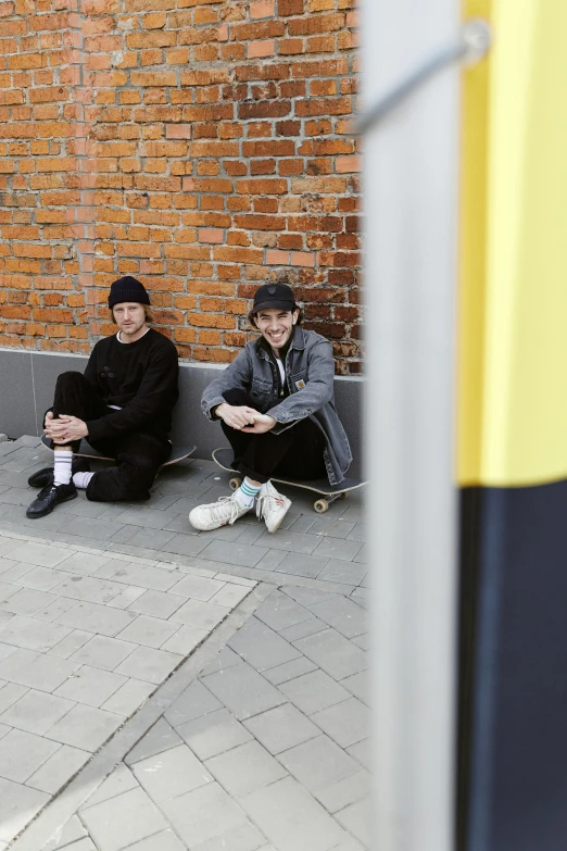 a man riding a skateboard down the side of a street, by Attila Meszlenyi, realism, two buddies sitting in a room, black. yellow, ivan shishkin and greg rutkowski, square