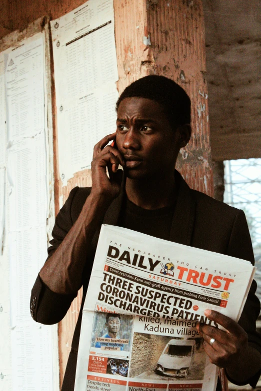 a man holding a newspaper while talking on a cell phone, an album cover, by Alasdair Grant Taylor, pexels contest winner, happening, dark skinned, meet the actor behind the scenes, young thug, trustworthy