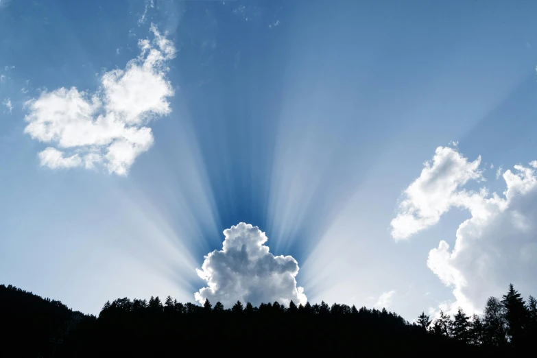 the sun is shining through the clouds in the sky, pexels contest winner, volumetric god rays, paul barson, bright blue sky, viewed from a distance